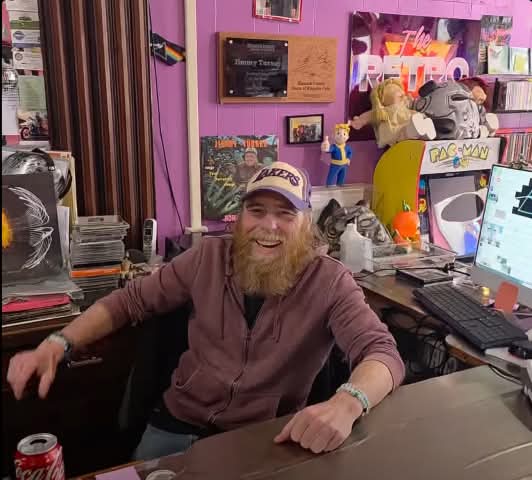 Smiling man sitting behind desk
