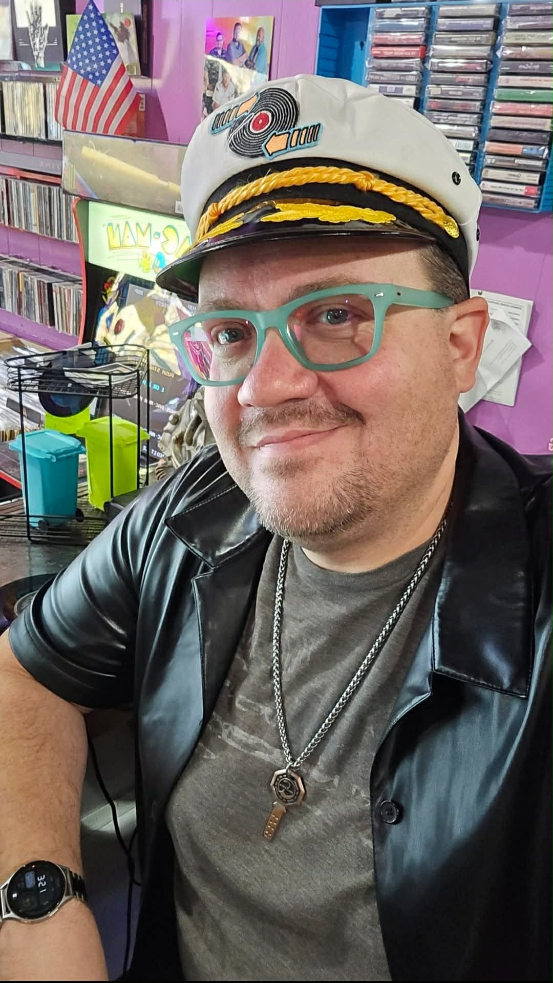 Smiling man in captain hat and glasses